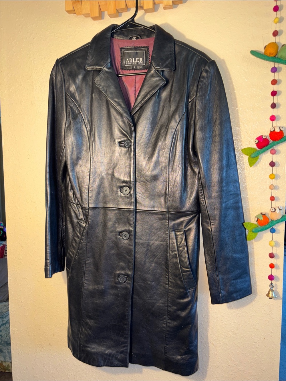 VINTAGE Adler Collection Long black leather button-front coat featuring a maroon